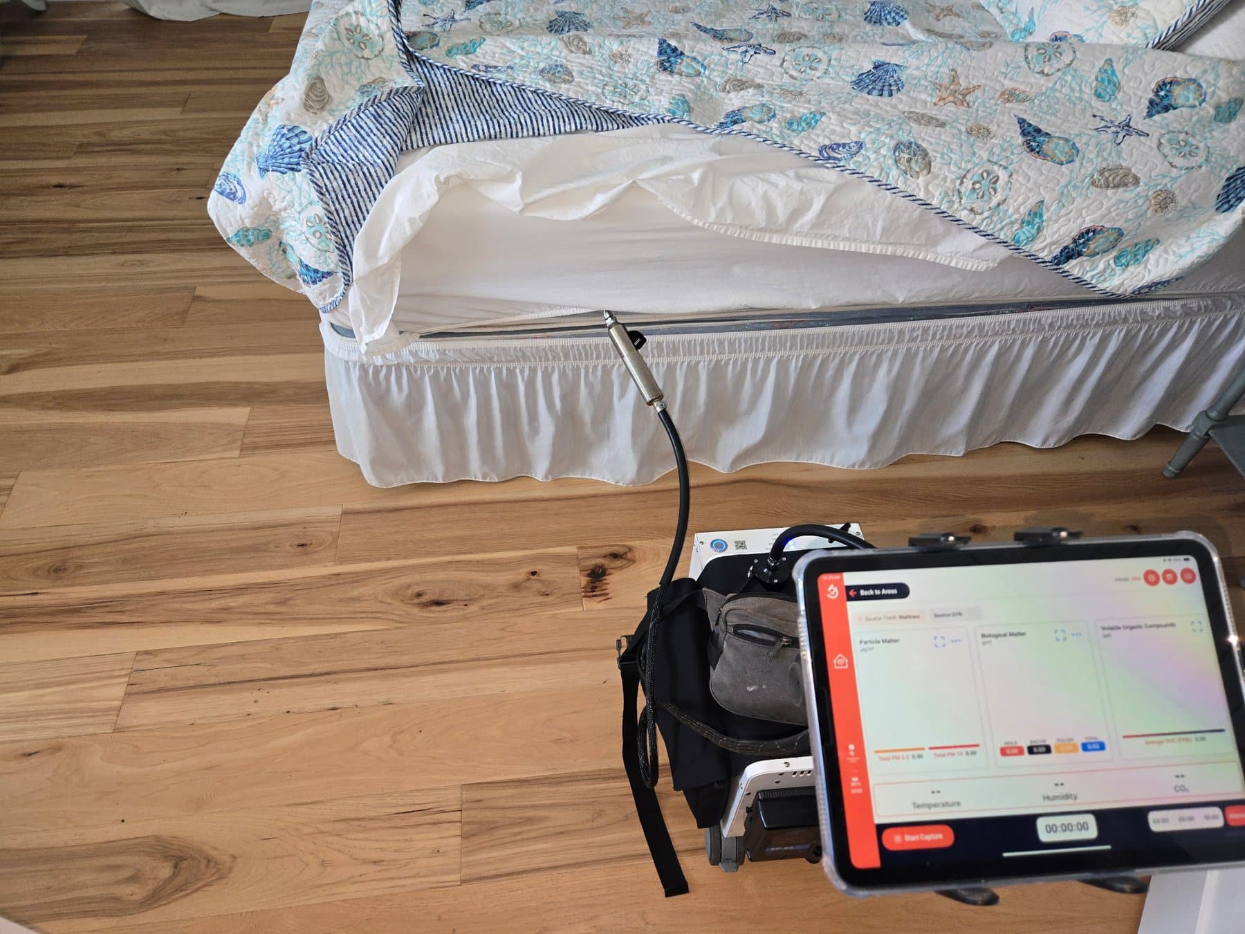 InstaScope sampling wand positioned at a mattress during a bedroom air survey