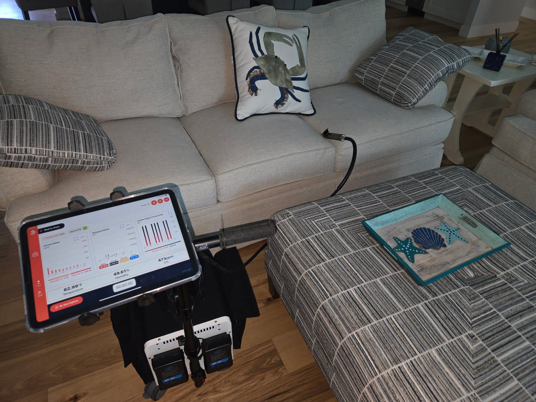InstaScope air monitor taking readings in a furnished living room