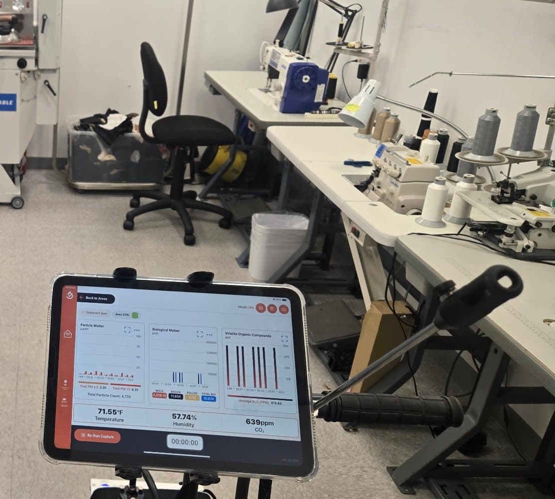InstaScope air monitor reading particle, biological and VOC levels inside a commercial workroom