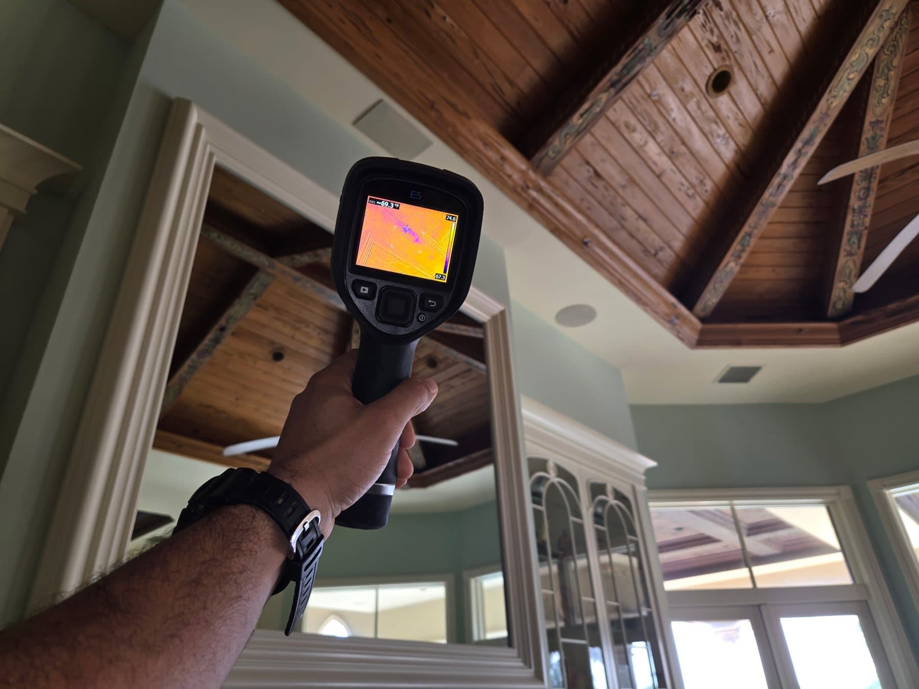 Thermal imaging camera aimed at a wood ceiling during a Mold Shark inspection